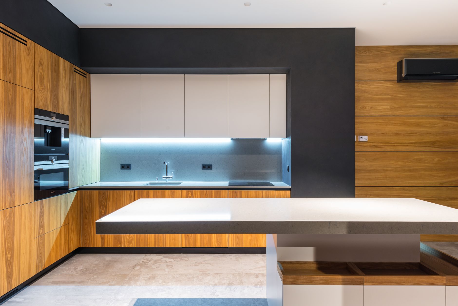Interior of light cozy kitchen with furniture in minimalist design and marble floor
